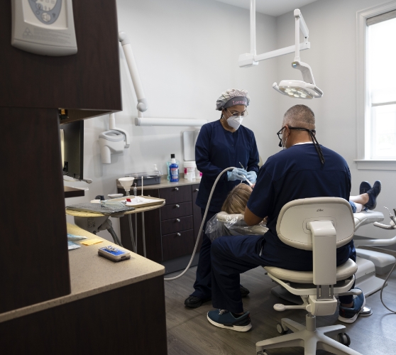 Dentist and assistant treating a patient