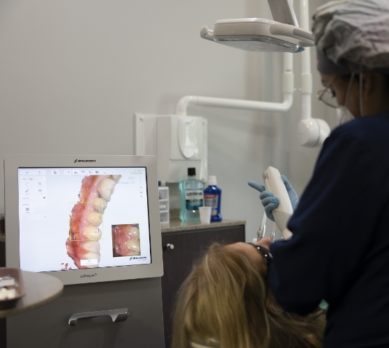 Dentist showing a patient close up photos of their teeth