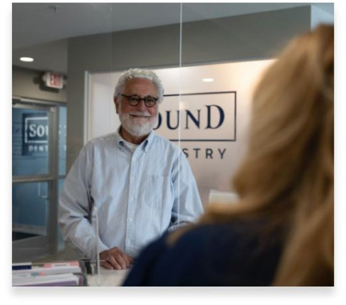 Dental patient checking in at reception desk