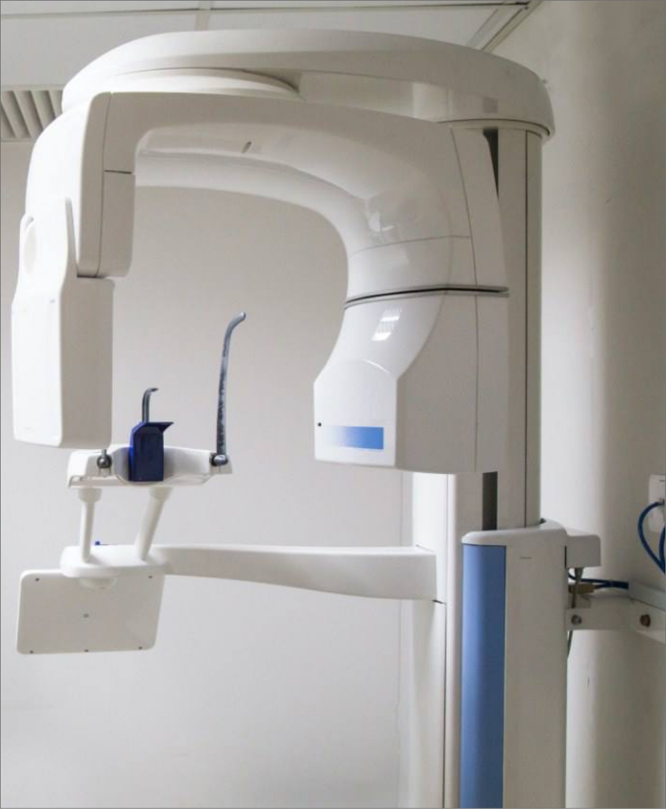 3 D C T cone beam x ray scanner standing against white wall