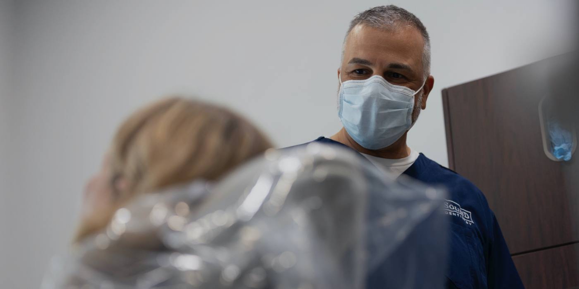 Easton dentist wearing face mask and smiling at a patient