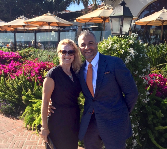 Doctor Kitsos smiling with her husband at outdoor garden