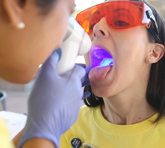 Woman receiving oral cancer screening from dentist