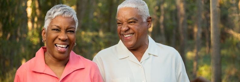 Older man and woman laughing together outdoors